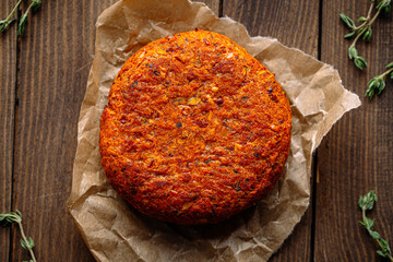 Big vegetarian falafel cutlet on the wooden background