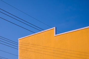 Street Minimal Architecture style of the old Vintage yellow Building Wall with electric cable lines...