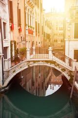 Fototapeta na wymiar Narrow canal with gondolas in Venice, Italy