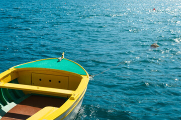 Yellow fishing boat on the background of the turquoise sea