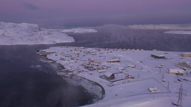 Aerial view of Teriberka village in winter. Flying over Teriberka to Barents sea. North of Russia