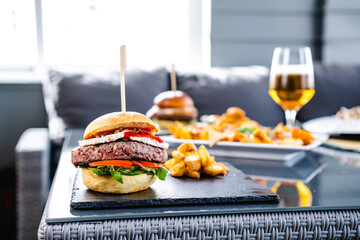 Delicious burger with potatoes and beer