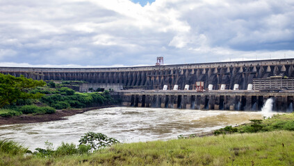 Photo of modern giant dam, located on Parana river. Itaipu Binacional hydroelectric power station...