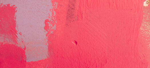 Messy paint strokes and smudges on an pink old painted wall. Colorful drips, flows, streaks of...