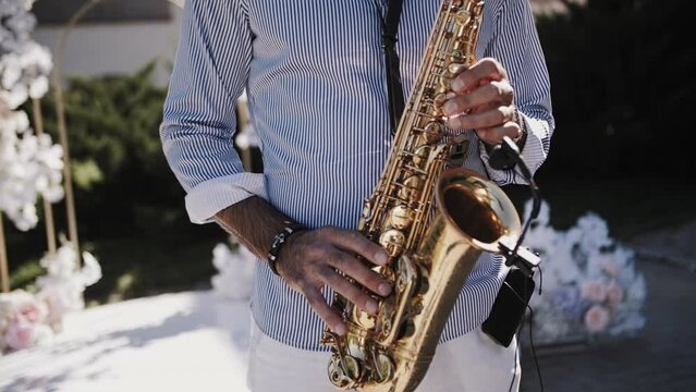 Saxophonist playing close-up at a wedding