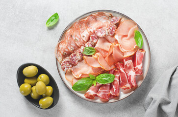 Cured Meat Platter, Antipasto Set, Appetizer Variety on Plate over Concrete Background