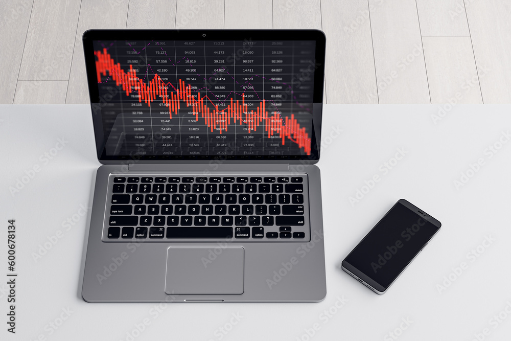 Poster close up of laptop and cellphone on desktop with falling red business graph grid on blurry backgroun