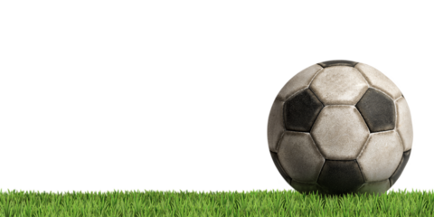 Close-up of an old black and white soccer ball (Football) isolated on white or transparent background with green grass. Png.