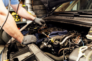 Technician changes car used fuel filter, car spare part. Car service concept.