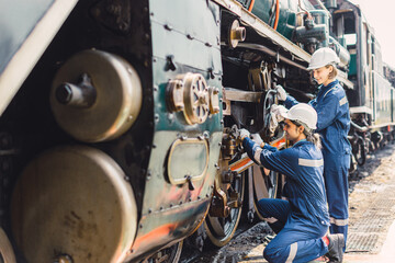 Train engineer team working service maintenance old dirty vintage classic steam engine locomotive...