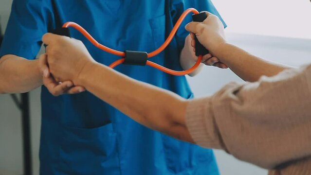 young asian physical therapist working with senior woman on walking with a walker