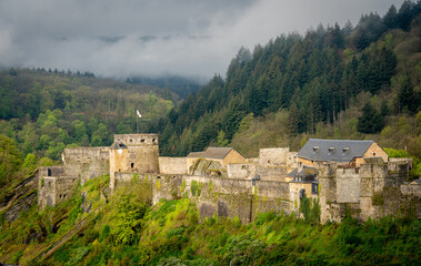 Fototapeta na wymiar Bouillon Castle and the forests of the Ardennes in Belgium on a misty morning