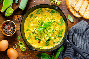 Omelette with Leek and Herbs, Delicious Snack or Breakfast on Rustic Wooden Background