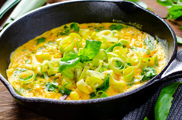 Omelette with Leek and Herbs, Delicious Snack or Breakfast on Rustic Wooden Background