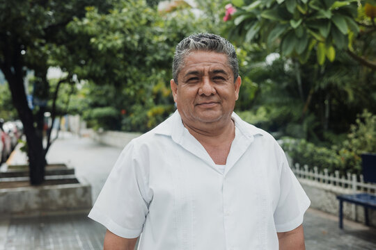latin senior man portrait looking at camera outdoors in the street in Mexico city, hispanic adult people