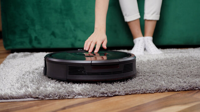 Close up of modern cleaning device helping to clean the carpet in the apartment