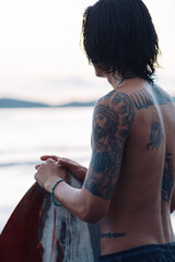 Surfing Outdoor Sport Activities Asian Male with Tattoos 
