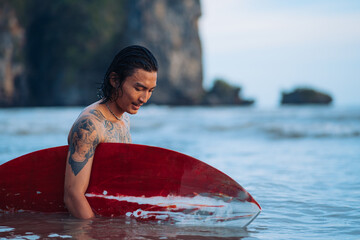 Surfing Outdoor Sport Activities Asian Male with Tattoos 
