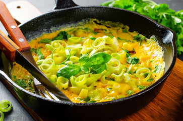 Omelette with Leek and Herbs, Delicious Snack or Breakfast on Rustic Wooden Background