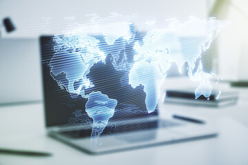 Double exposure of abstract digital world map on laptop background, research and strategy concept