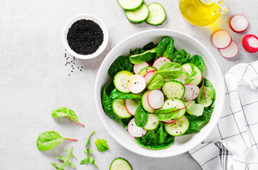 Fresh Salad with Radish, Cucumber and Lettuce on Bright Background, Healthy Vegetarian Food