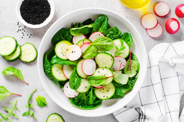 Fresh Salad with Radish, Cucumber and Lettuce on Bright Background, Healthy Vegetarian Food