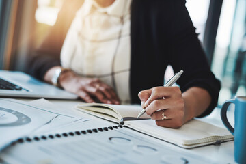 Business woman, hands and writing in a office with planning notes and corporate notebook. Female person, employee and work planner book with company paperwork and charts for professional project