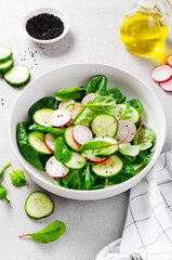 Fresh Salad with Radish, Cucumber and Lettuce on Bright Background, Healthy Vegetarian Food