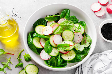 Fresh Salad with Radish, Cucumber and Lettuce on Bright Background, Healthy Vegetarian Food