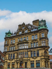 Emerson Chambers building in Newcastle City Centre featuring a copper enclosed clock on top.
