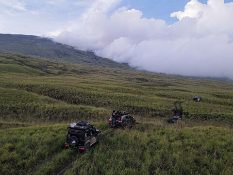Drone view overlander passing through the tambora mountain savanna in the afternoon