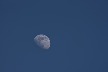 MOON - Earth satellite on the background of blue sky