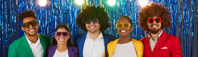 Portrait of five funny male and female retro disco party people on shiny foil background. Headshot...