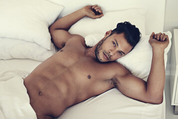 Portrait, naked and man in a bed in the morning, fitness and muscular at home, serious and confident. Face, male person and guy in the bedroom, muscle and sexy with wellness, nude and shirtless