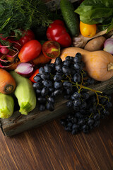 Fresh organic vegetables from above wood background