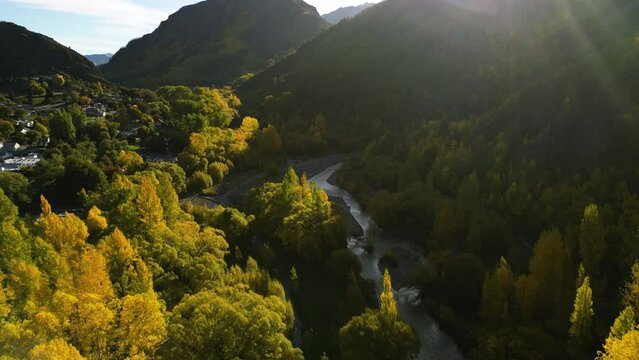Iconic Arrowtown with vibrant autumn colors in New Zealand, aerial drone view
