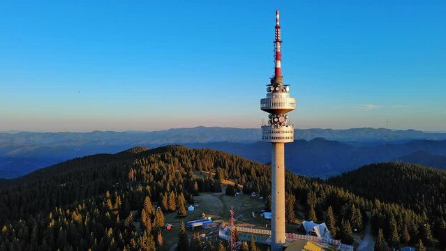 Tower Snezhana on peak of Snezhana covered with spruce forests in Rhodope mountains