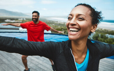 Fitness, wellness and couple doing outdoor yoga stretching together on a rooftop of a building. Happy, smile and young man and woman doing a pilates warm up exercise or workout for health in nature.