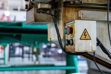 Hight voltage sign on machine at industrial plant. Occupational and safety caution sign for worker in factory concept.