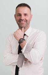 Naklejka premium casual businessman wearing formal business clothes smiling at camera with crossed hands isolated over gray background.