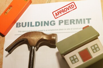 Building Permit concept with “approved” text on a residential home .