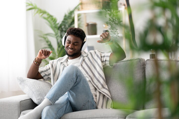 Black man dancing on sofa