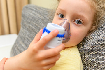 The child breathes through an inhaler. Treatment of colds and allergies.