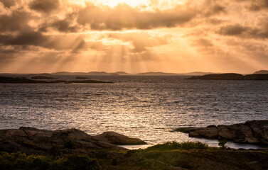 Fototapeta na wymiar dramatic sunbeams over sea shore