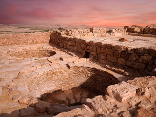 Ancient city in the Israeli desert in the pink rays of sunrise
