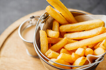 delicious hot crispy french fries on a rustic background