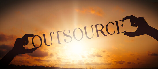 Outsource - human hands holding black silhouette word