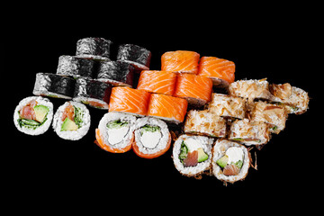 sushi roll with cream cheese salmon shrimp cucumber avocado set on a black mirror background