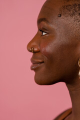 Profile view of smiling young woman wearing jewelry