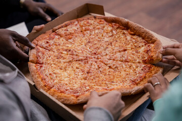 Group of friends eating pizza